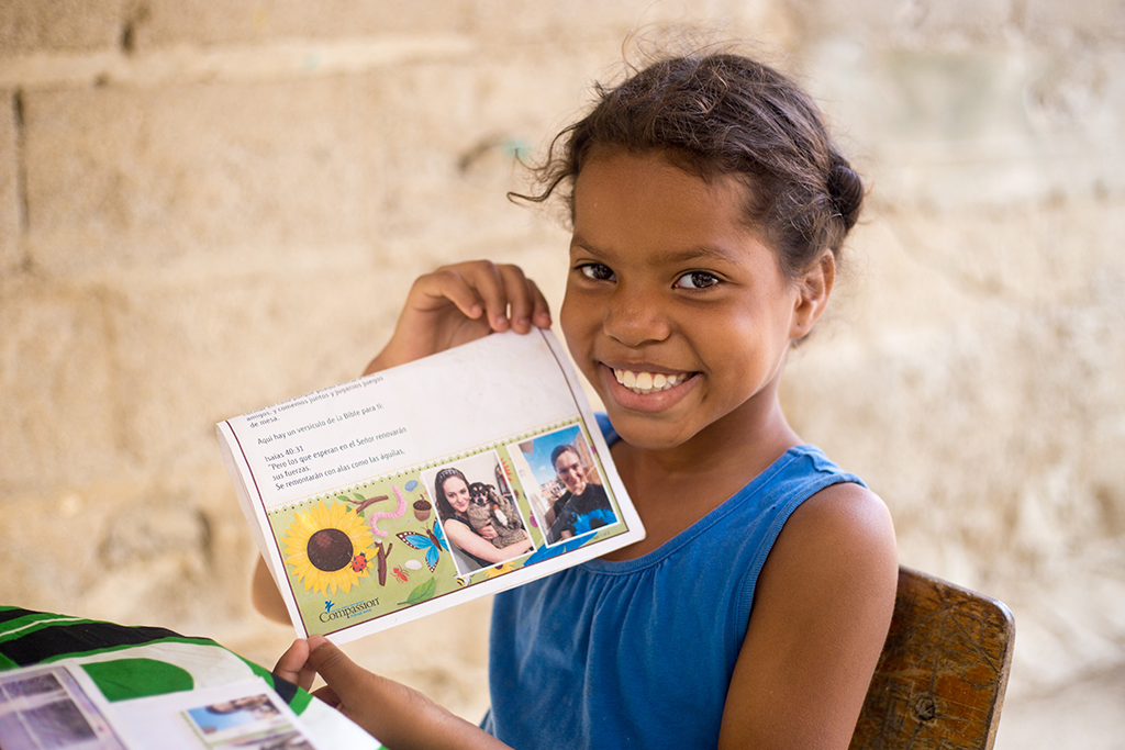 A girl happy holding up a letter